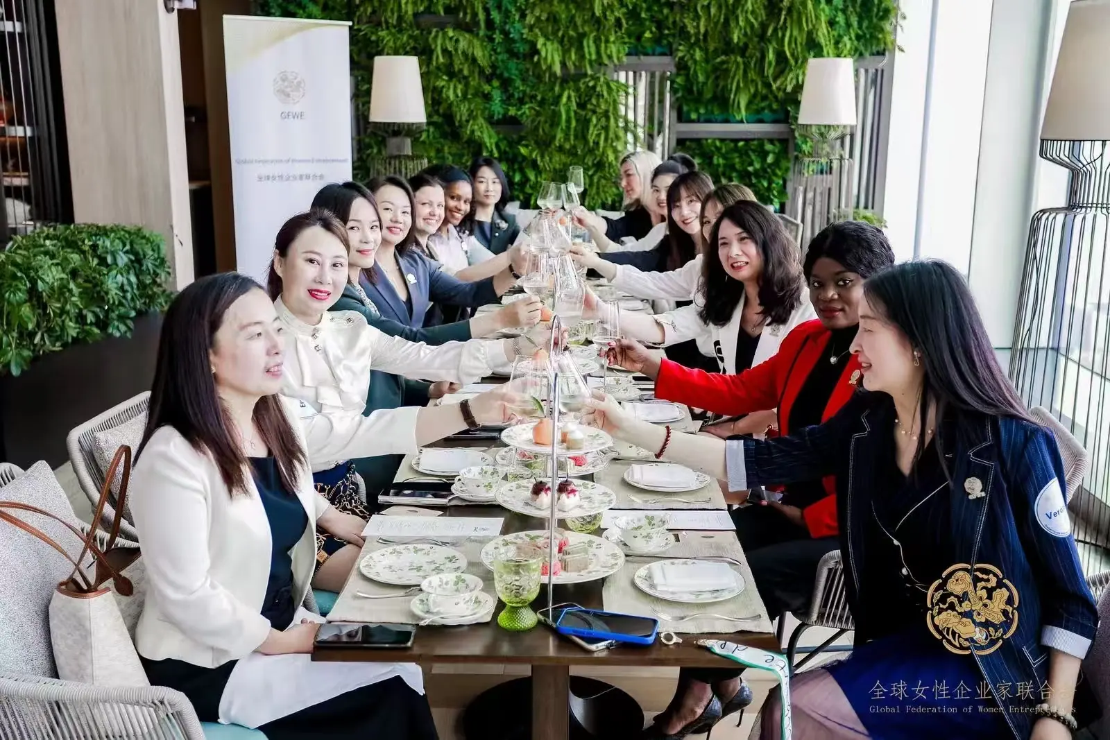 Guests raise a toast at the afternoon-tea table during the GFWE gathering