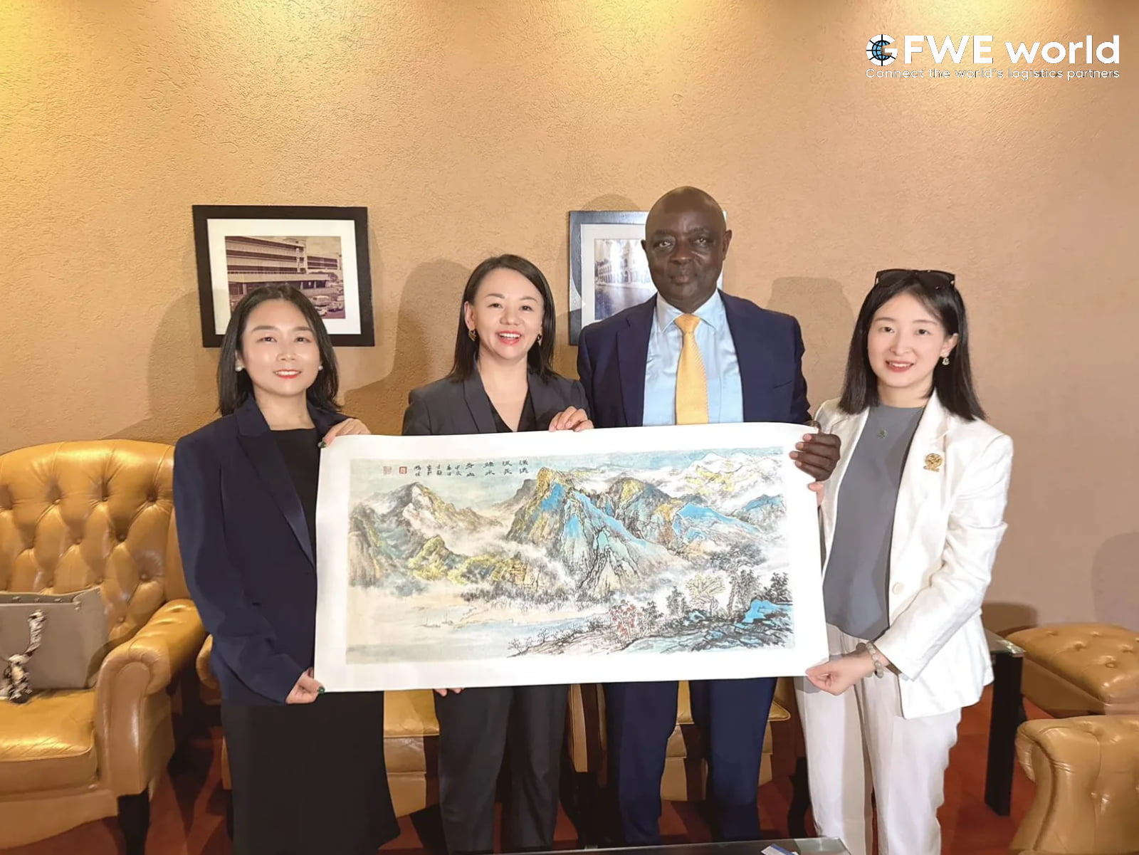 GFWE representatives with Hon. Vincent Bamulangaki Ssempijja, Senior Presidential Advisor of Uganda, presenting a traditional Chinese landscape painting